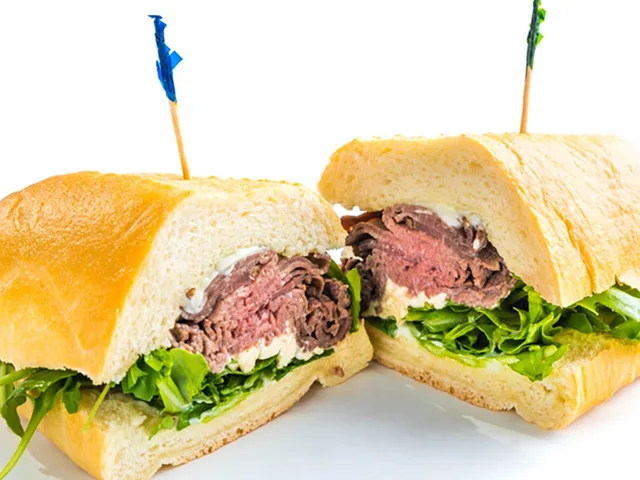 Baby Blue sandwich with roast beef and blue cheese crumbles, halved