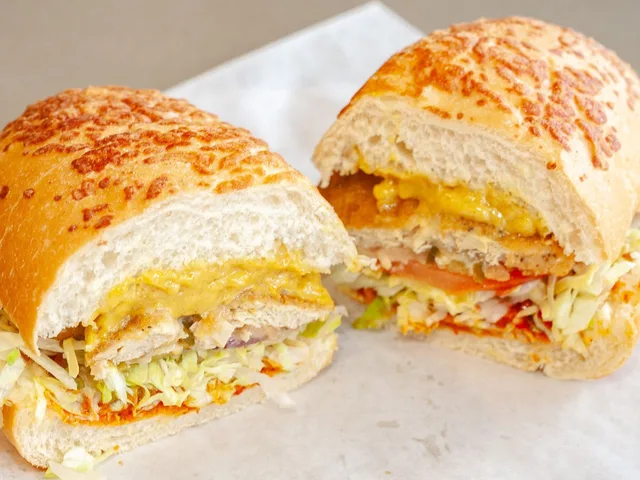 Chick Chick Curry sandwich with vegan chick'n nuggets and curry mayo, halved