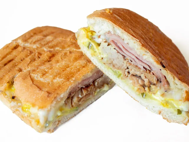 Cubano sandwich, panini grilled, halved