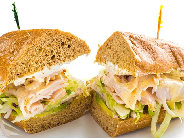 Dirty Bird sandwich with turkey, cream cheese and avocado, halved