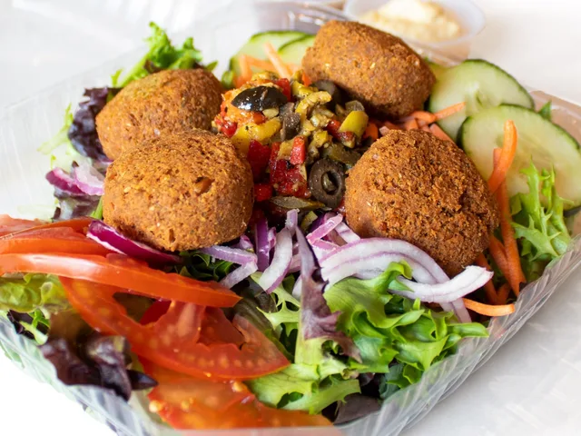 Falafel salad with hummus, tomatoes and mixed greens