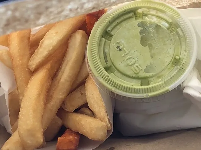 French fries with a cup of house-made cilantro lime ranch