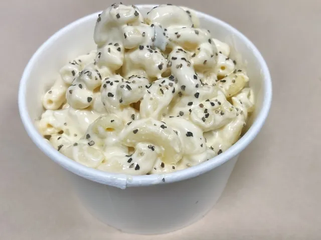 Macaroni salad topped with black sesame seeds