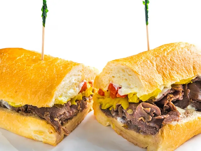 Papacini sandwich with roast beef, mozzarella and marinated peppers, halved