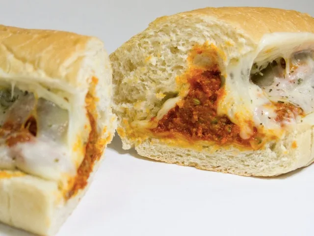 The Meatball sandwich with marinara and melted cheese, halved