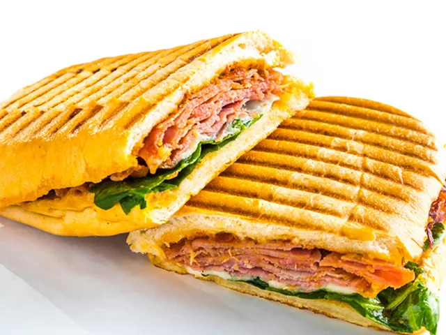 The Melt sandwich with prosciutto, salami, mozzarella and provolone, panini grilled, halved