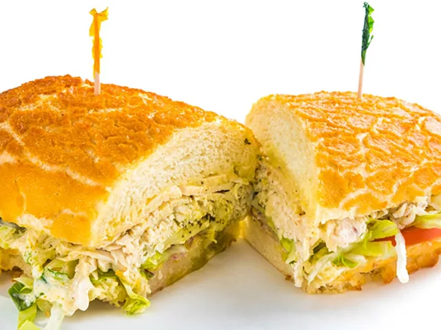 The Pesto Chic sandwich with chicken, mozzarella and basil pesto, halved