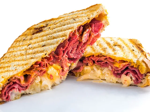 The Rueben sandwich, panini grilled, halved