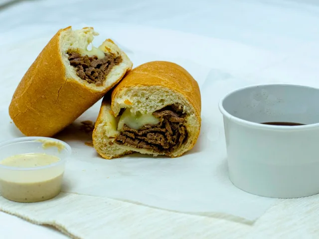 Tri Tip French Dip sandwich with a cup of au jus and horseradish